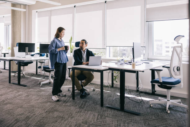 istock Two Japanese colleagues working together at the office 2164341817