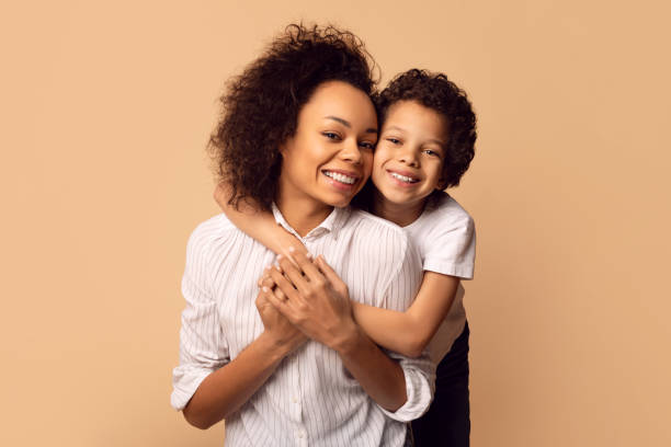istock Smiling Mother Embracing Her Young Son in Warm Indoor Setting 2164343083