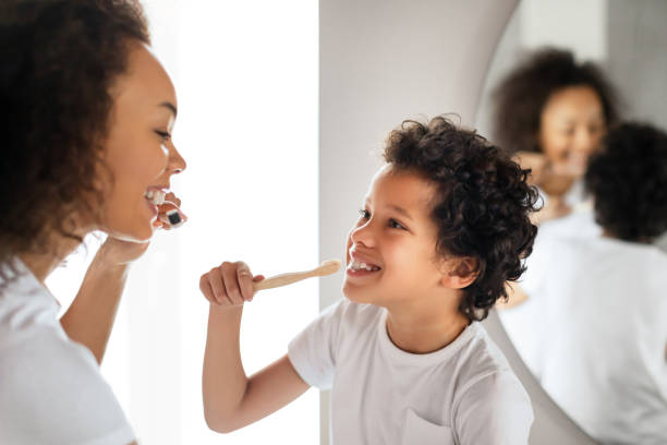istock Young Mother Teaching Her Son to Brush Teeth 2164343088