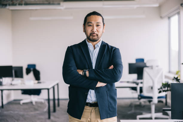 istock Confident Asian businessman in modern office room 2164345796
