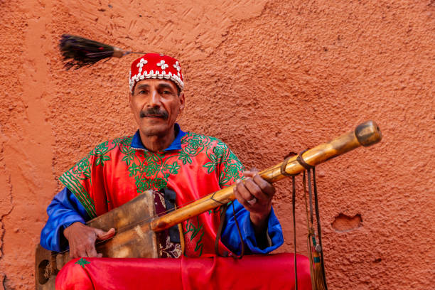 Moroccan street musician in traditional costume on Djemaa el Fna square, Marrakech, Morocco. Djemaa el Fna is a heart of Marrakesh's medina quarter.