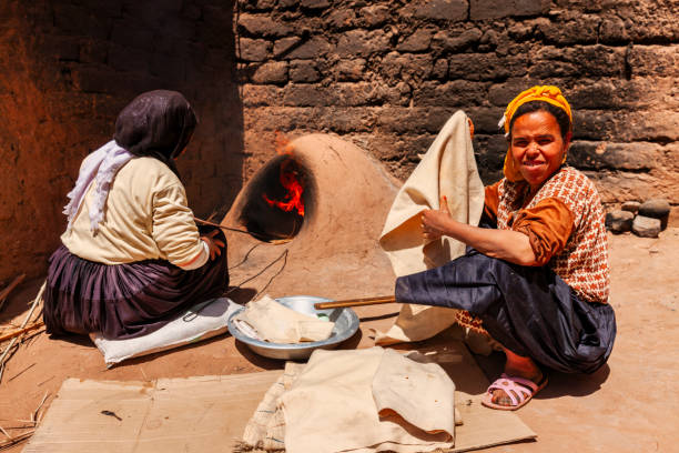 istock Moroccan women baking bread - khubz 2164348229