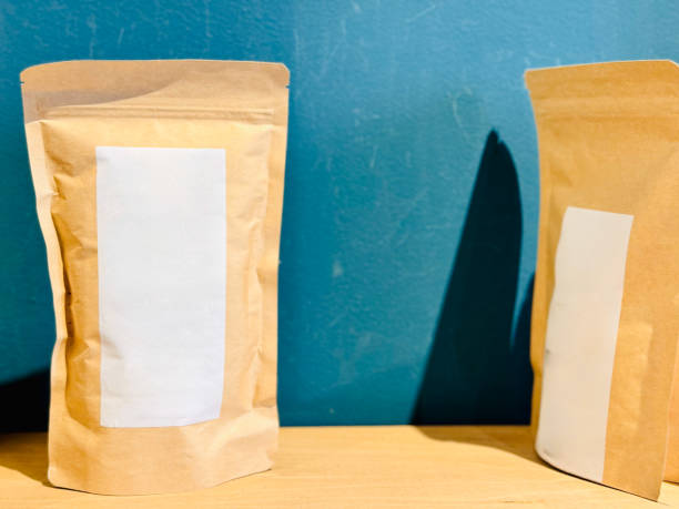 Brown paper bags with blank labels, organized neatly on a shelf.
