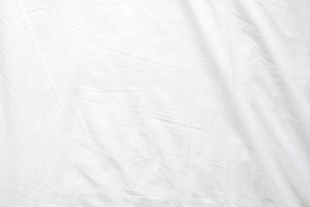 Abstract White Bedding Sheets or White wrinkled fabric background texture and Texture with copy-space :Creased or wrinkled white fabric,Soft focus