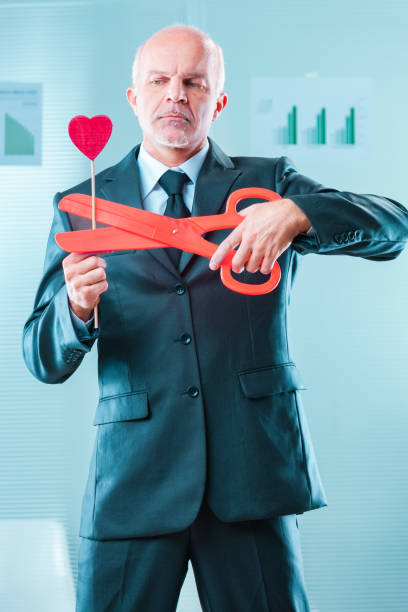 istock Stern look, cutting heart, emotional manipulation symbolized 2164360954