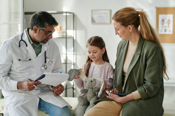 istock Mother and daughter visiting doctor 2164367881