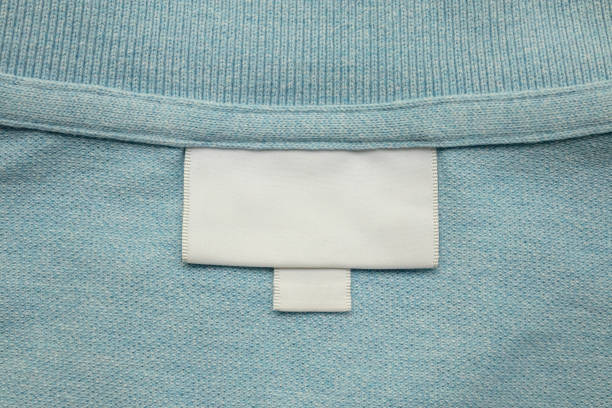 istock White blank laundry care clothes label on blue shirt fabric background 2164372688