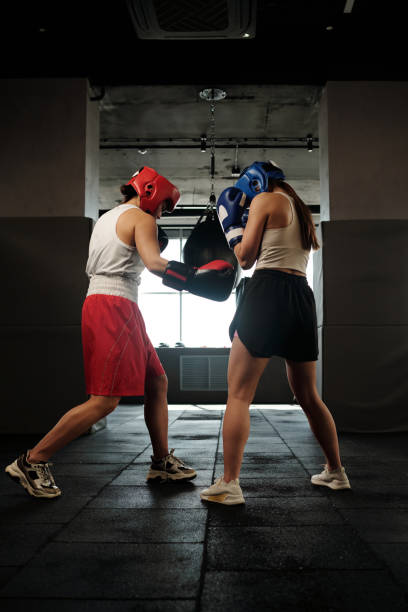 Girls practicing boxing exercises in gym