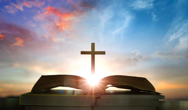 istock Open book with cross on sunset background. Christian concept. 3D Rendering 2164375344
