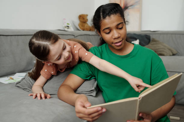 istock Discussing picture in book with sitter 2164383449