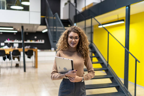 istock Cheerful businesswoman with digital tablet at work 2164384987