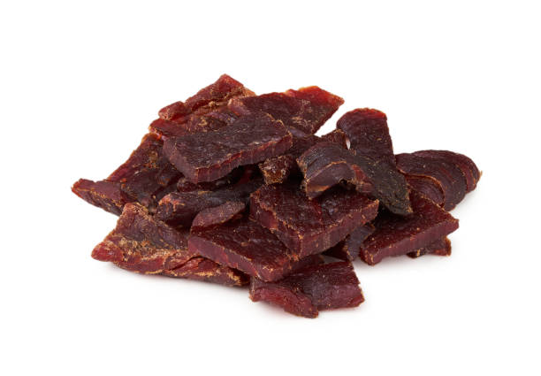 istock closeup pile of beef jerky isolated on white background 2164392145