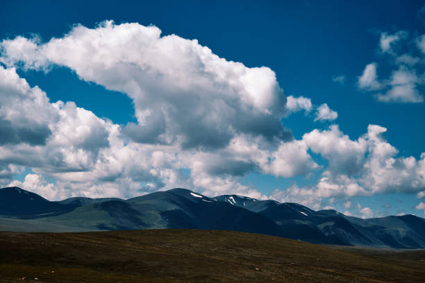 Atmospheric landscape: shadows of clouds on mountain peaks