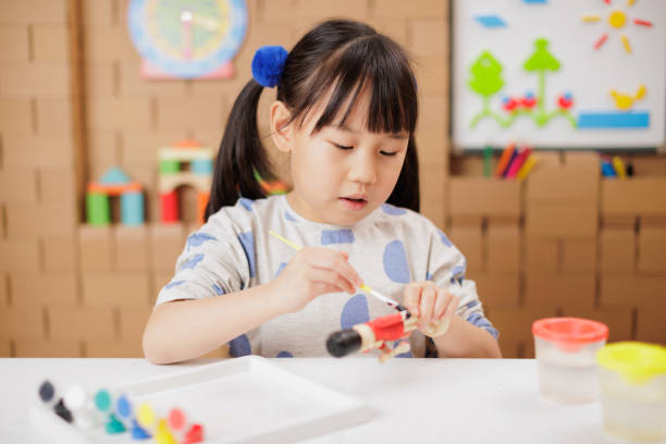 istock young girl making craft at home 2164399712