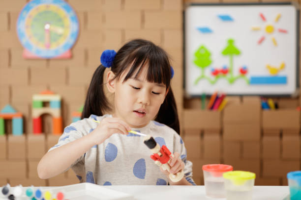 istock young girl making craft at home 2164399746