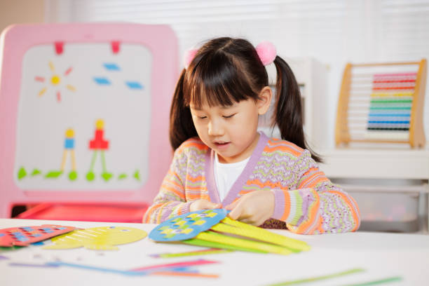 istock young girl making craft at home 2164399790
