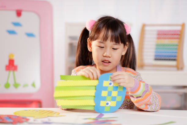 istock young girl making craft at home 2164400025