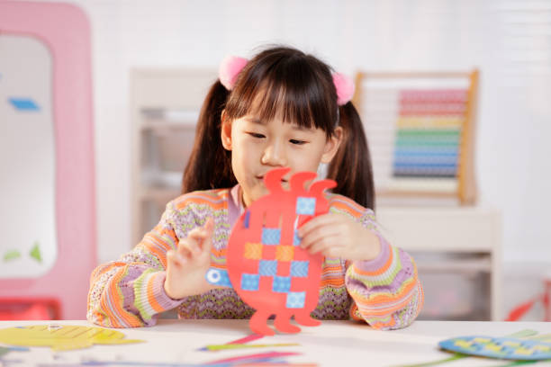 istock young girl making craft at home 2164400040