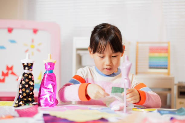 istock young girl making craft at home 2164400270