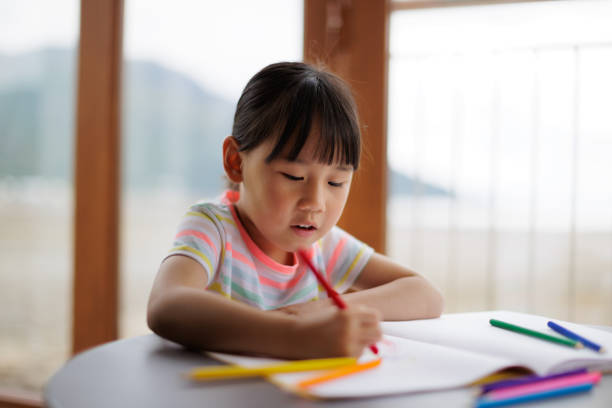 istock young girl drawing various shapes for learning 2164400272