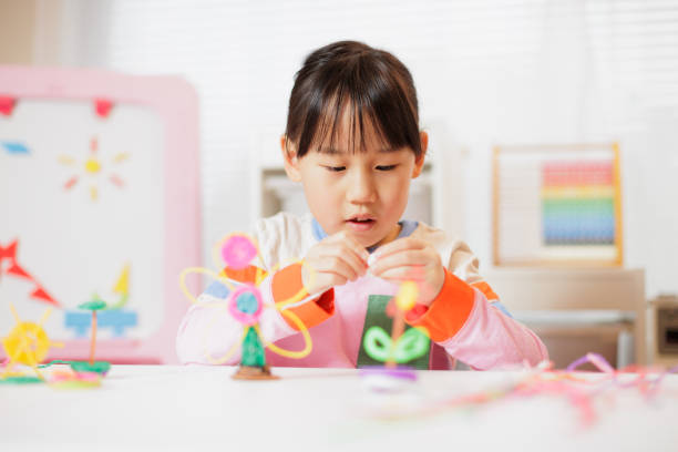 istock young girl making craft at home 2164400765