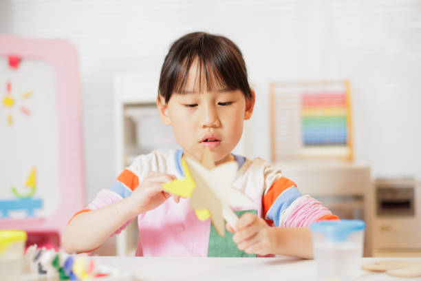 istock young girl making craft at home 2164400797