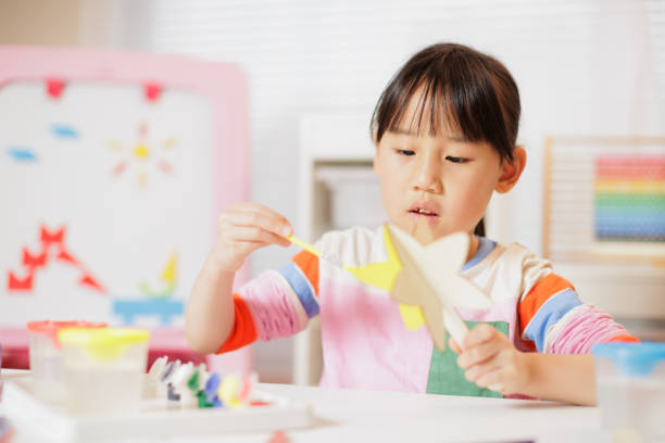 istock young girl making craft at home 2164400798