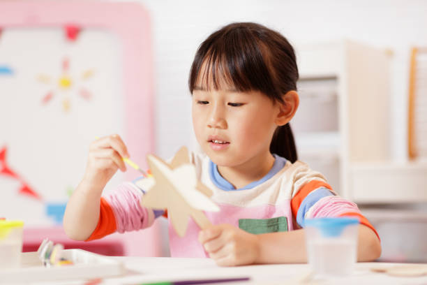 istock young girl making craft at home 2164400847