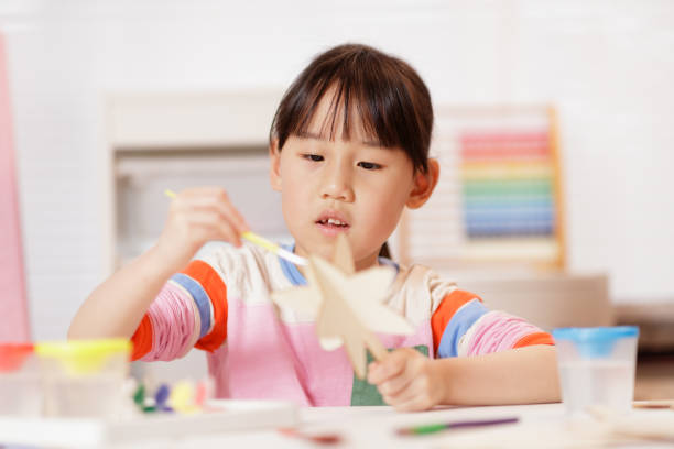 istock young girl making craft at home 2164400848