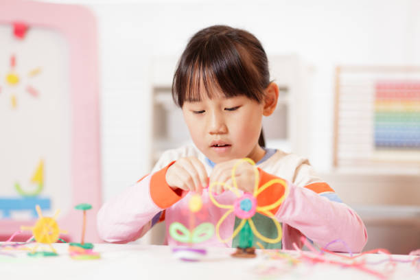 istock young girl making craft at home 2164400853