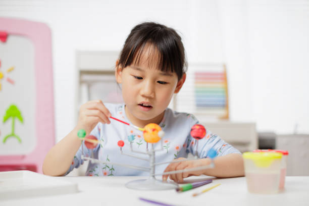 istock young girl making craft at home 2164401239