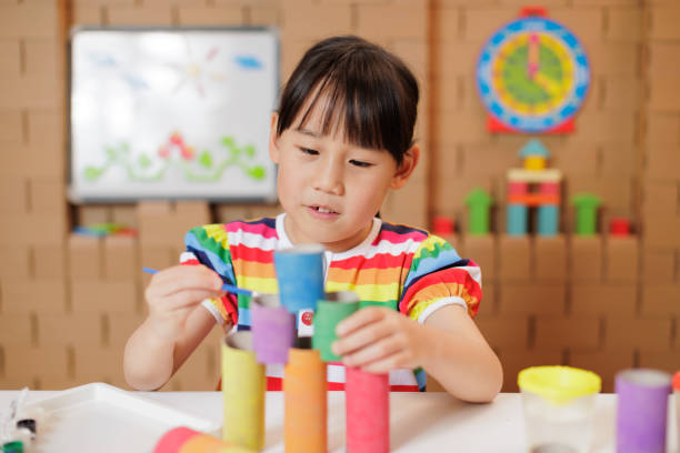 istock young girl making craft at home 2164401306