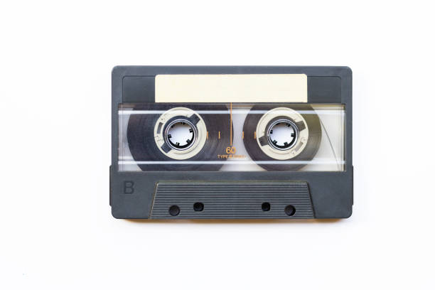 Old gray blue music cassette with blank sticker on white background - top view