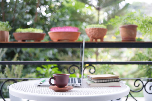 istock earthenware clay coffee cup at the balcony and Laptop side view 2164404252