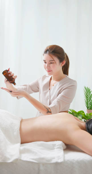 asian masseur essential oil hand