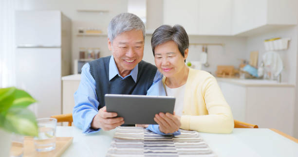 asian elderly couple use tablet
