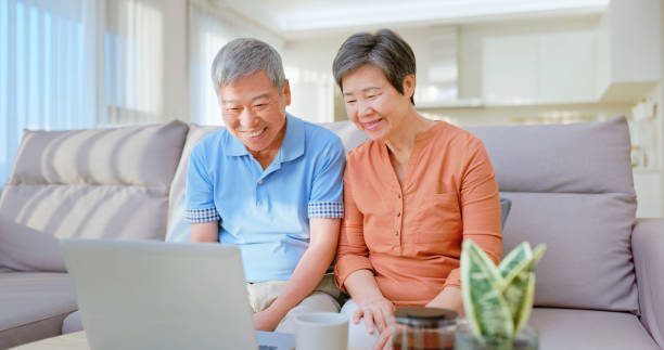 istock Asian elderly couple watch laptop 2164412897