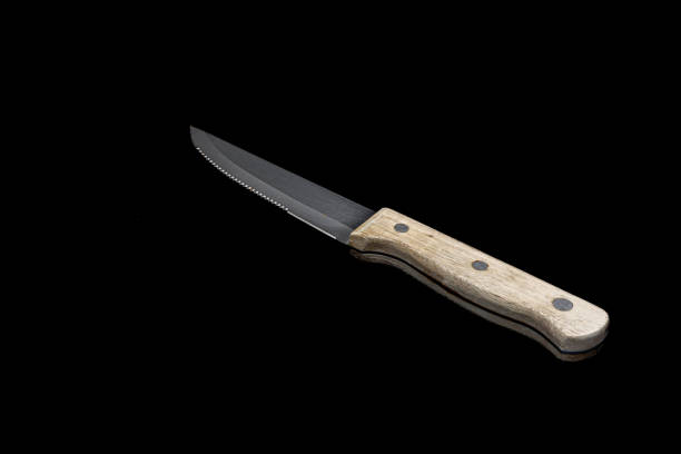 istock Rustic Wooden Handle Meat Cutting Knife on Black Background 2164415344