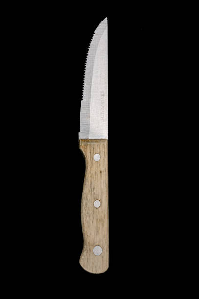 istock Rustic Wooden Handle Meat Cutting Knife on Black Background 2164415456