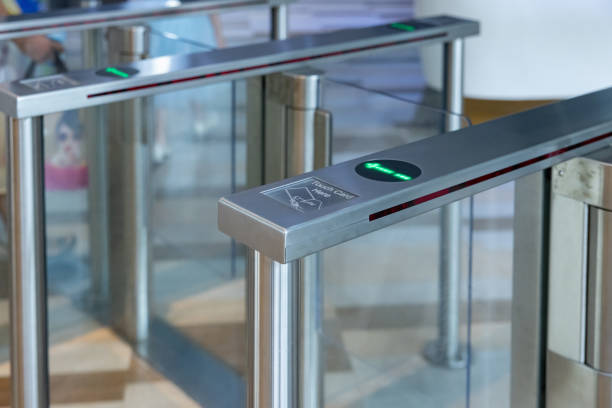 istock A metal gate with a green light on electronic turnstiles. 2164417411
