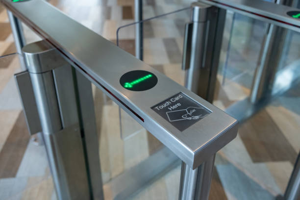 istock A metal gate with a green light on electronic turnstiles. 2164417415