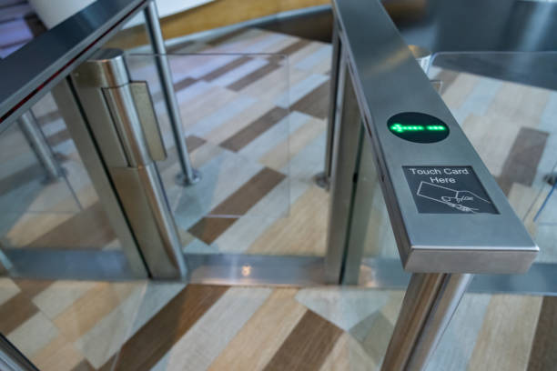 istock A metal gate with a green light on electronic turnstiles. 2164417416