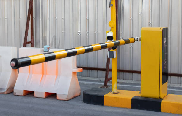 istock A yellow and black pole with a camera on top of it. car park barrier, automatic entry system 2164418387
