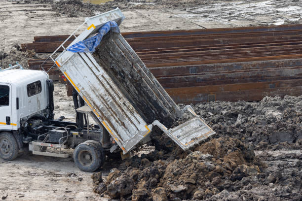 istock A dump truck is dumping dirt into a pile 2164418827