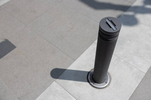 istock A black pole with a grey cap sits on a grey sidewalk 2164418891