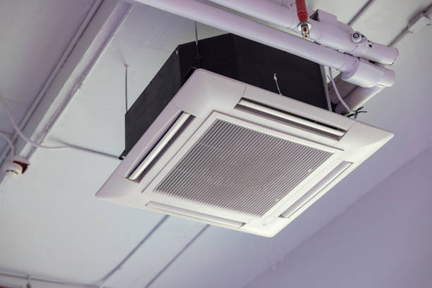 istock A white air conditioner is hanging from the ceiling. cassette type air conditioner. 2164419110