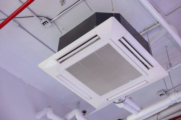 istock A white air conditioner is hanging from the ceiling. cassette type air conditioner. 2164419119