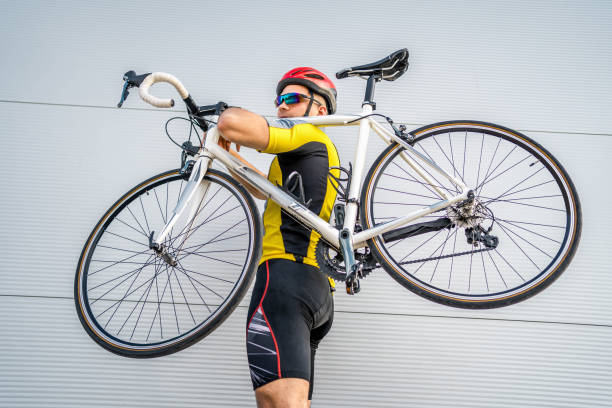 istock Cyclist carrying his bicycle 2164425380