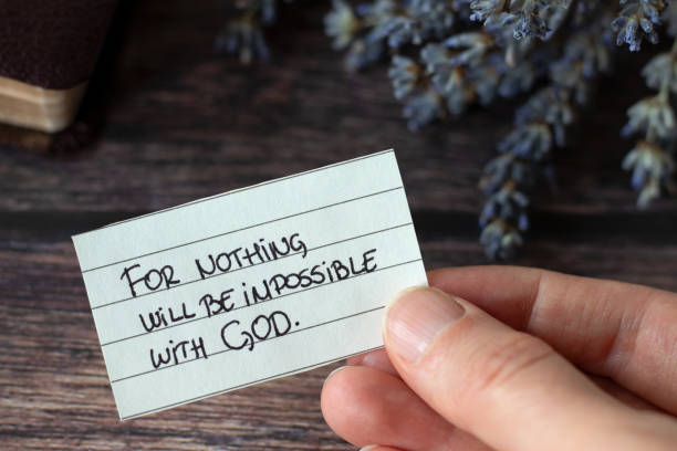 istock Hand holding handwritten note: Nothing will be impossible with God, close-up 2164425518