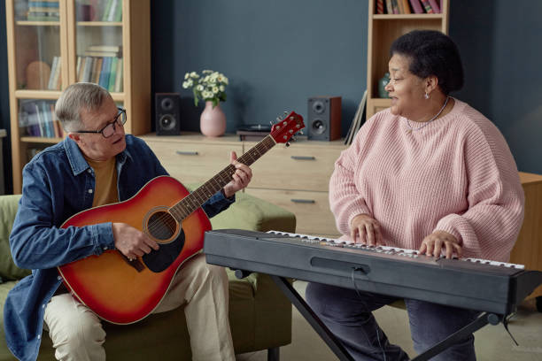 istock Mature People Duo Playing Music Singing 2164427130